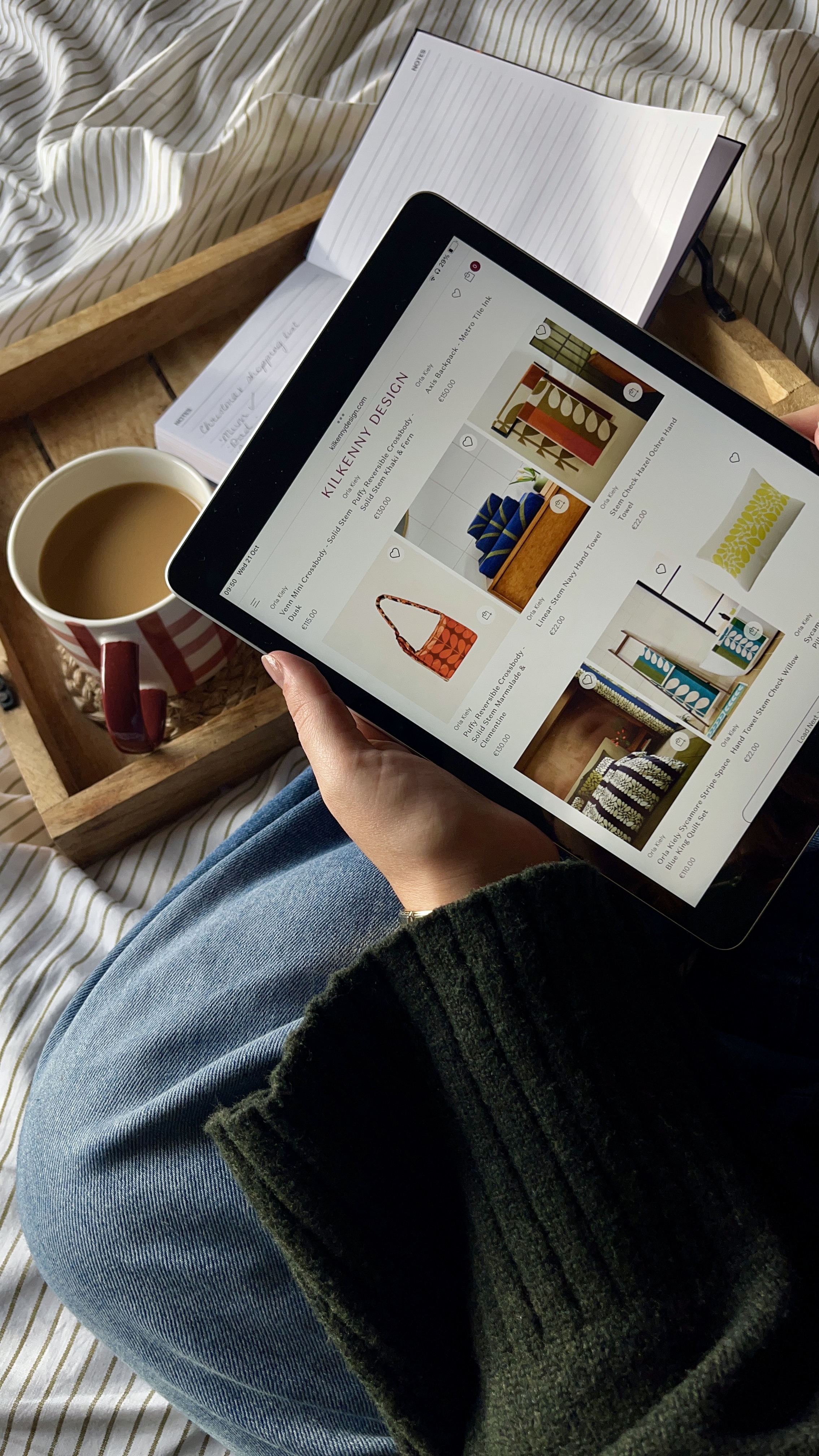 overhead shot of a woman browsing kilkenny design website for irish gifts